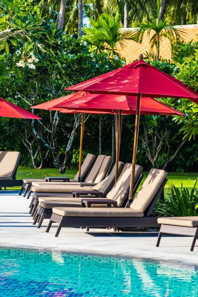 Lounge chairs around a resort pool